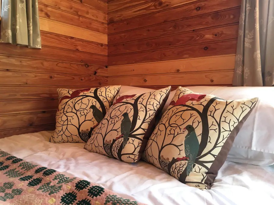 comfy bed awaits inside the shepherds hut at Tremorran AirBnB in Cornwall